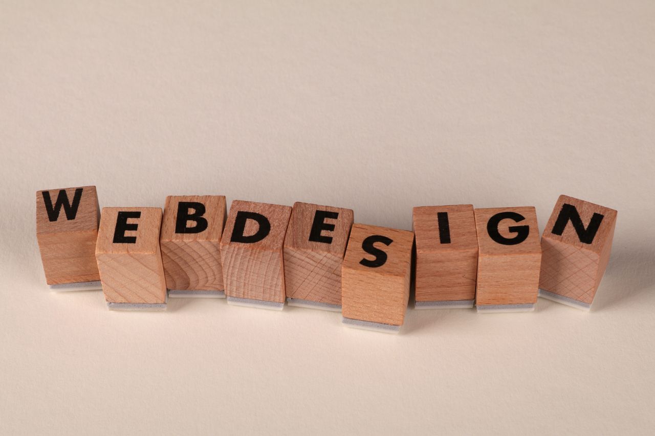 about-02 Wooden cubes arranged to spell web design illustrate the concept of digital creativity.